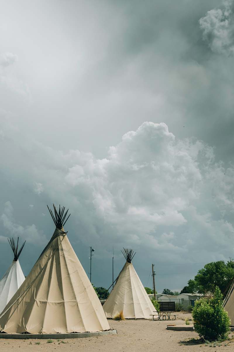 grey white teepee tents under cloudy sky nature