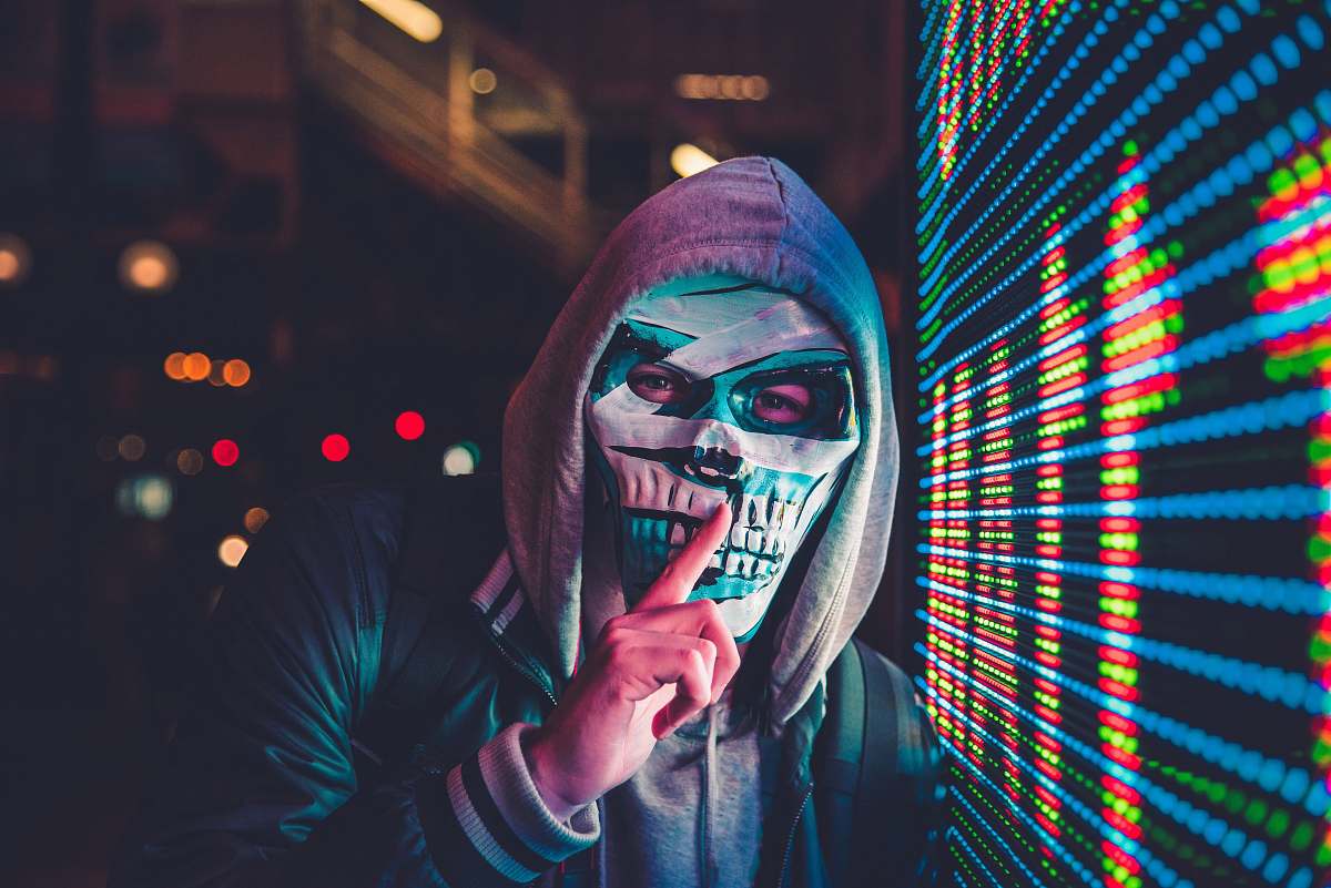 scary person standing near LED sign clown