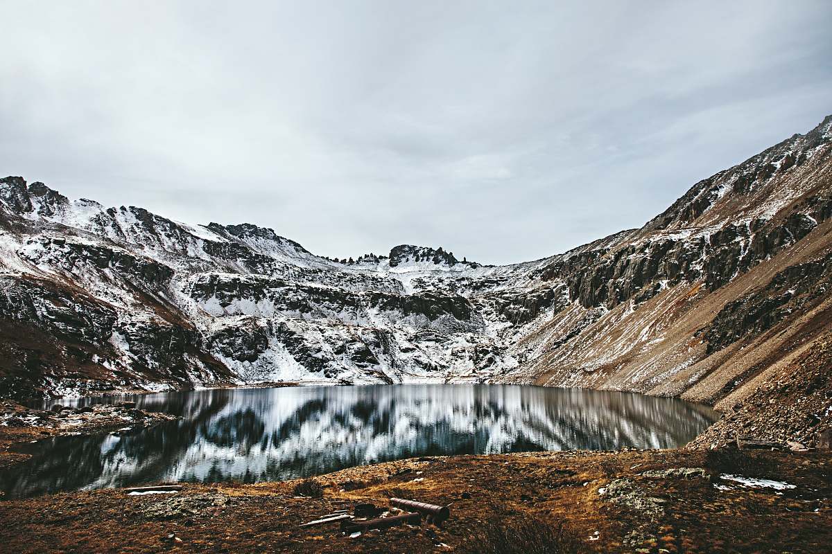 glacier brown rocky mountain beside body of water ice