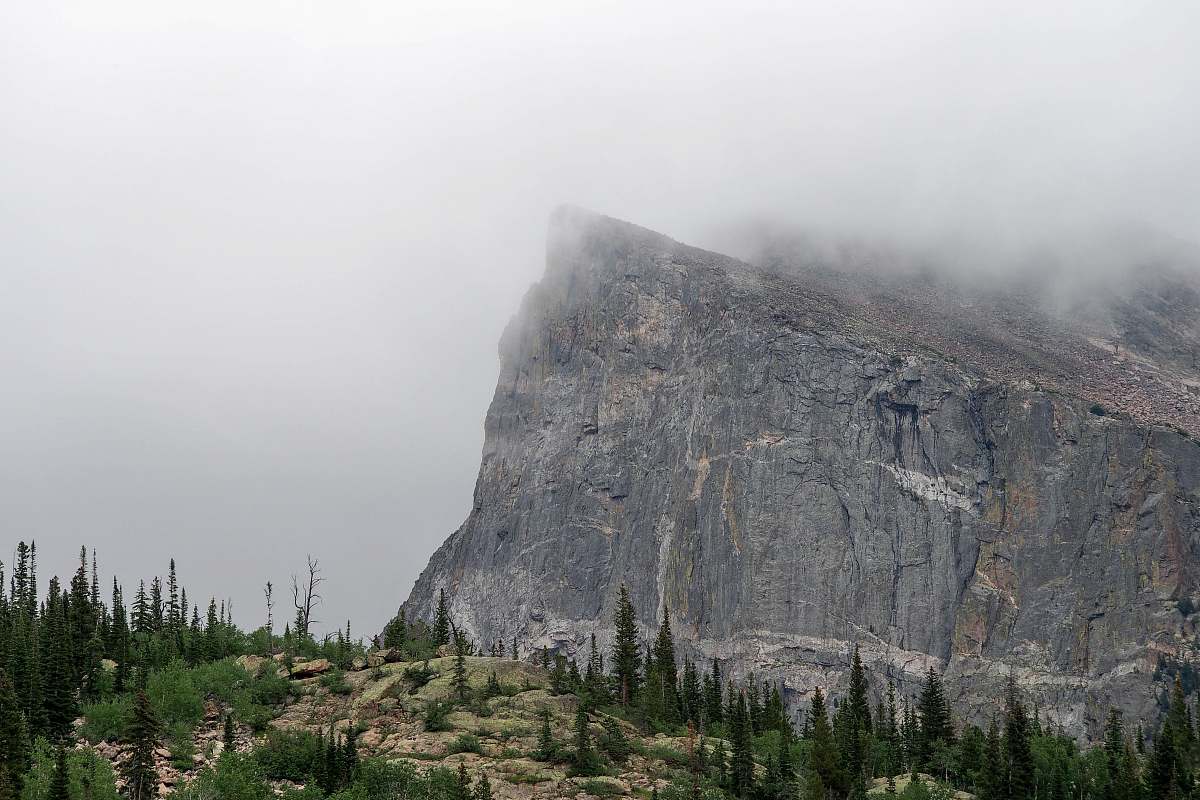 grey mountain covered by fog mountain range