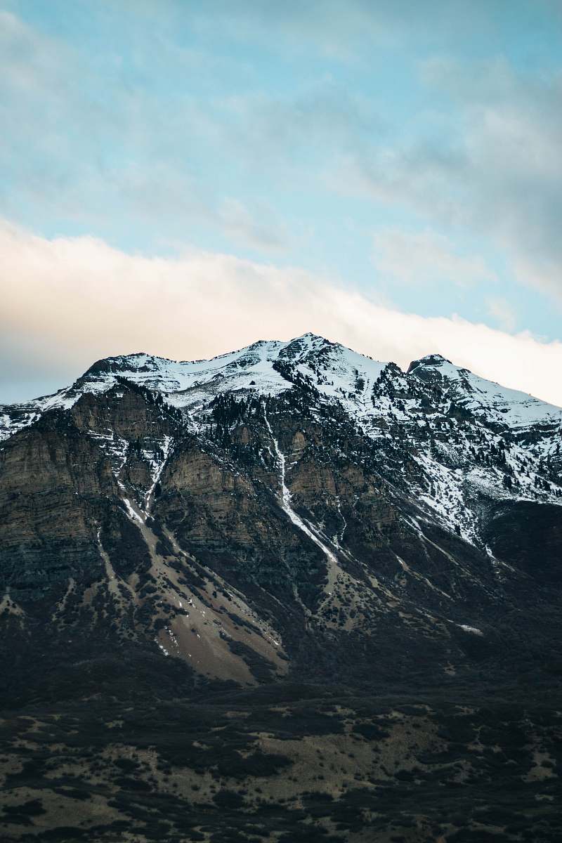 crest snow capped mountain under cloudy sky mountain range