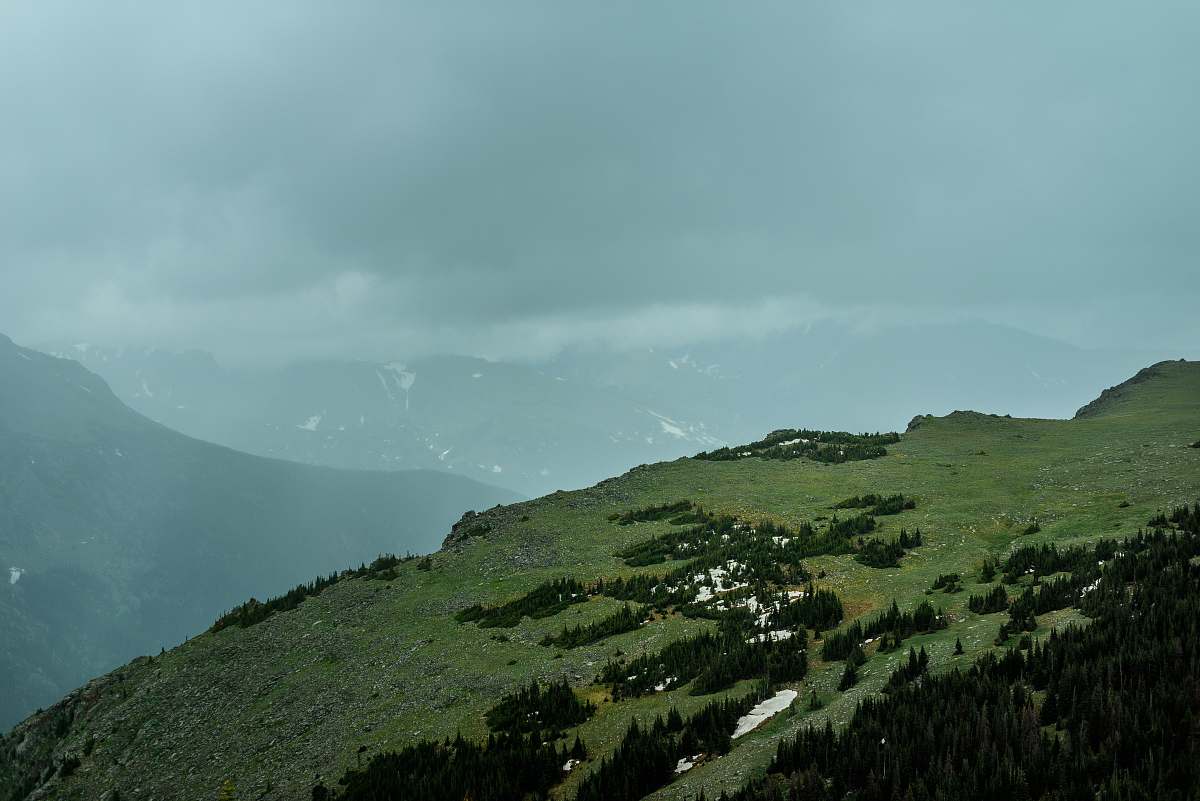 outdoors aerial photography of mountain under cloudy sky slope