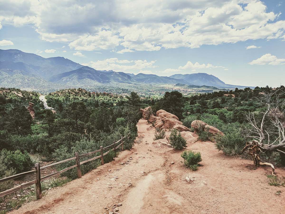 outdoors brown dirt road with brown wooden fence during daytime ground