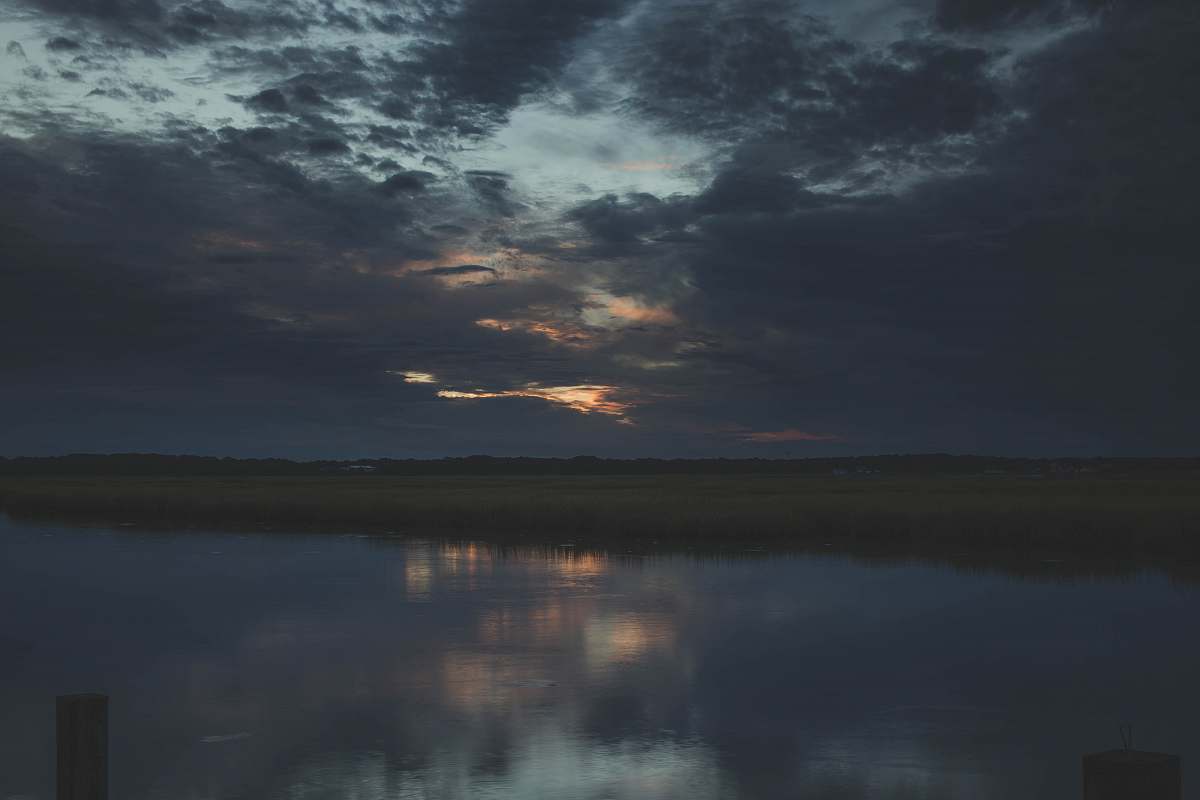 outdoors calm body of water under gray skies water
