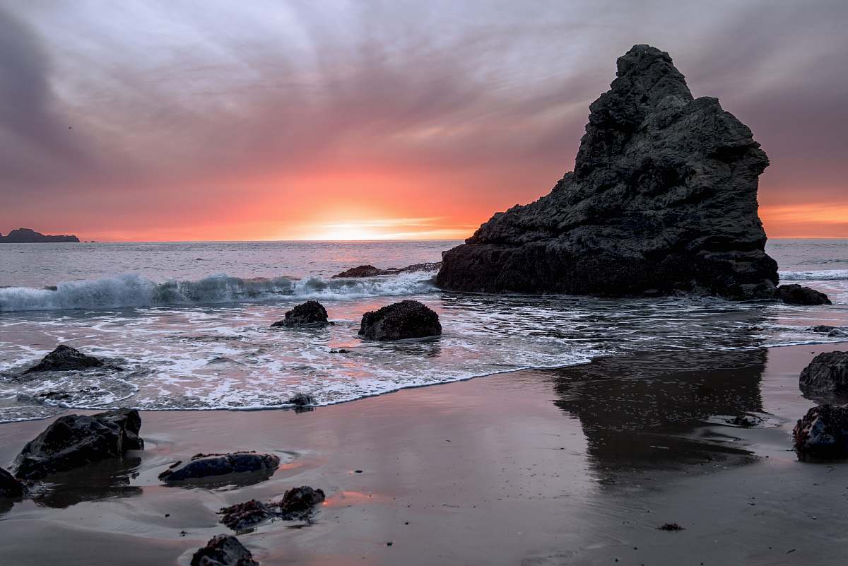 ocean gray rock on body of water during daytime outdoors