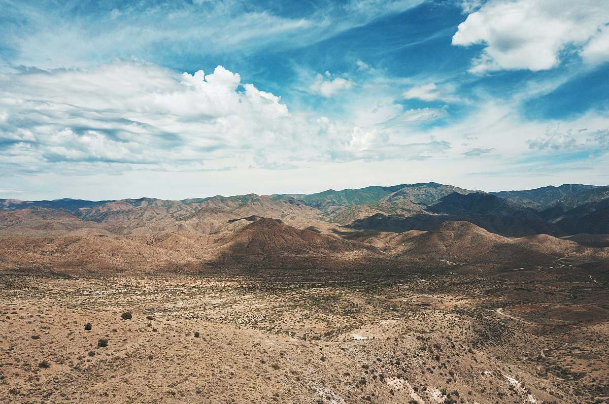 outdoors mountain under blue and white skies ground