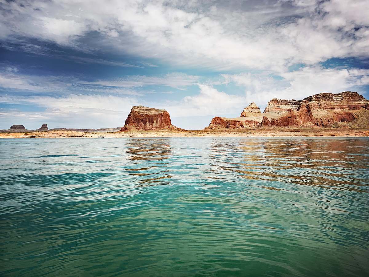 water mountains near body of water during daytime outdoors