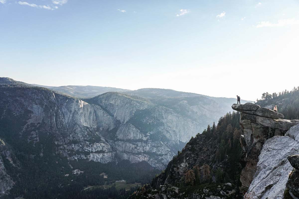 mountain person standing on edge of mountain outdoors