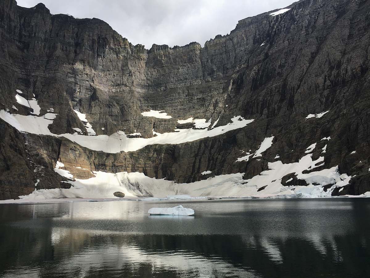 outdoors photo of body of water near mountain snow