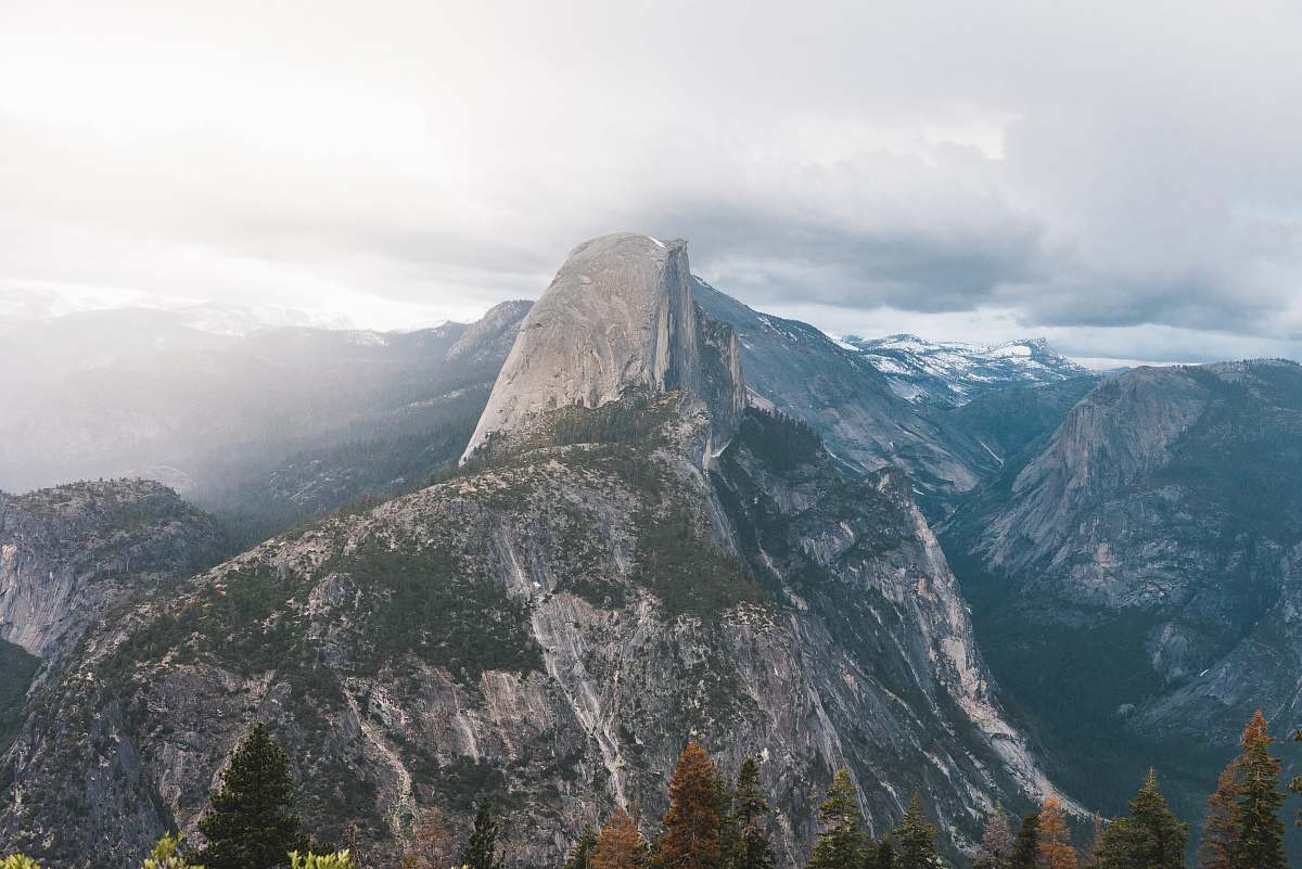 mountain photo of gray mountain under white clouds at daytime crest