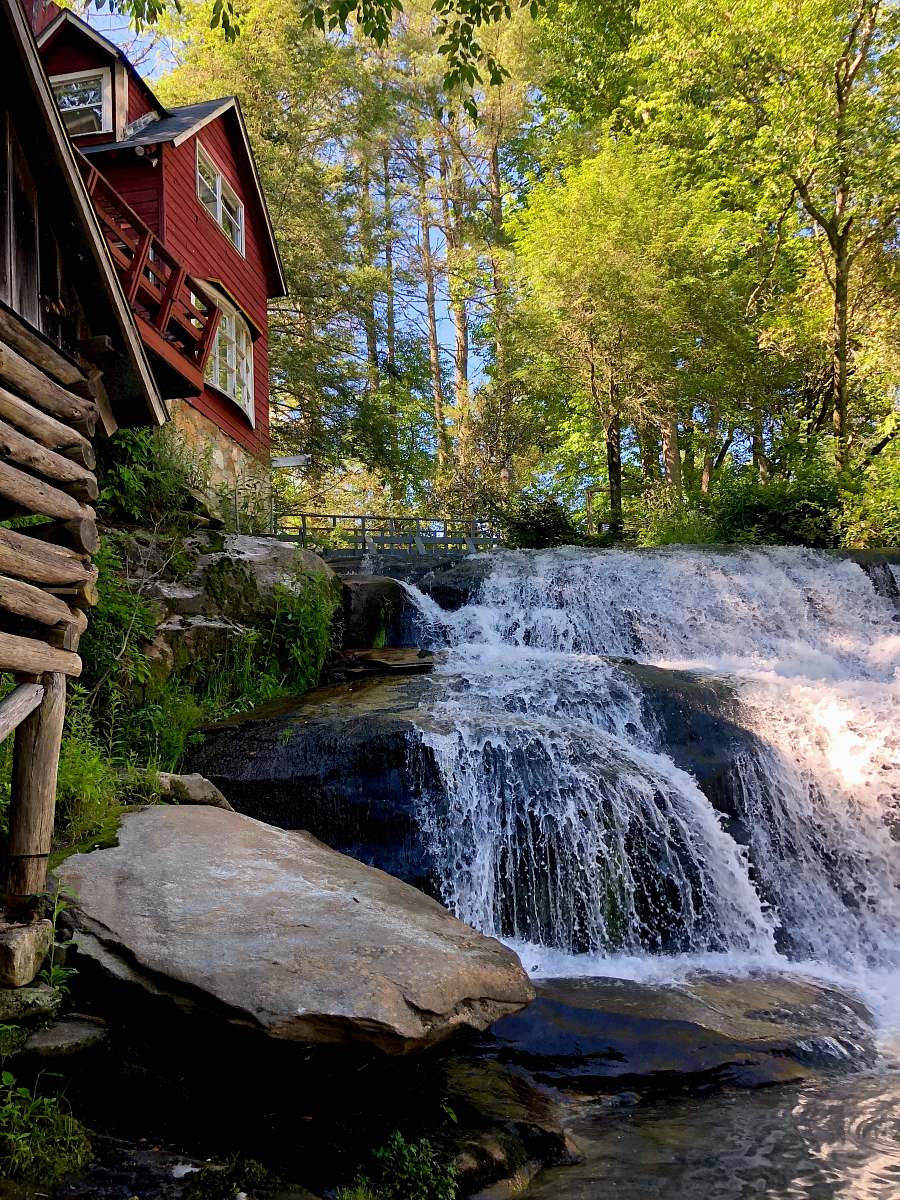 outdoors red wooden house river
