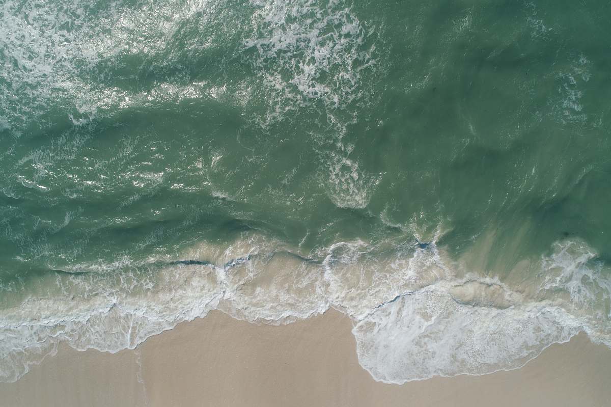 water seawave on seashore with white sand grey