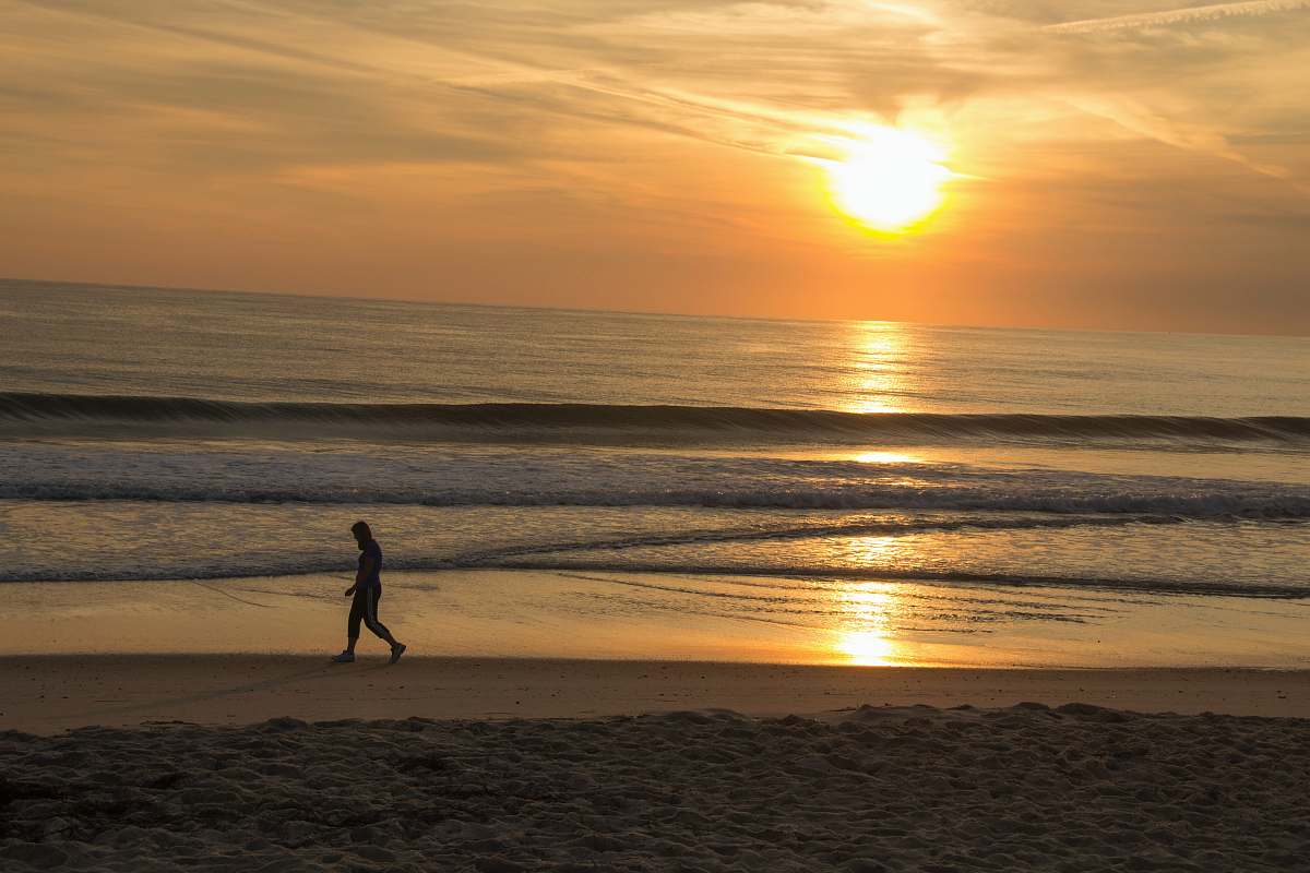 human silhouette of walking person ocean
