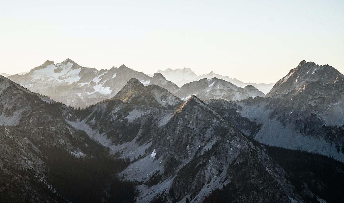 mountain snow covered brown mountain during daytime crest