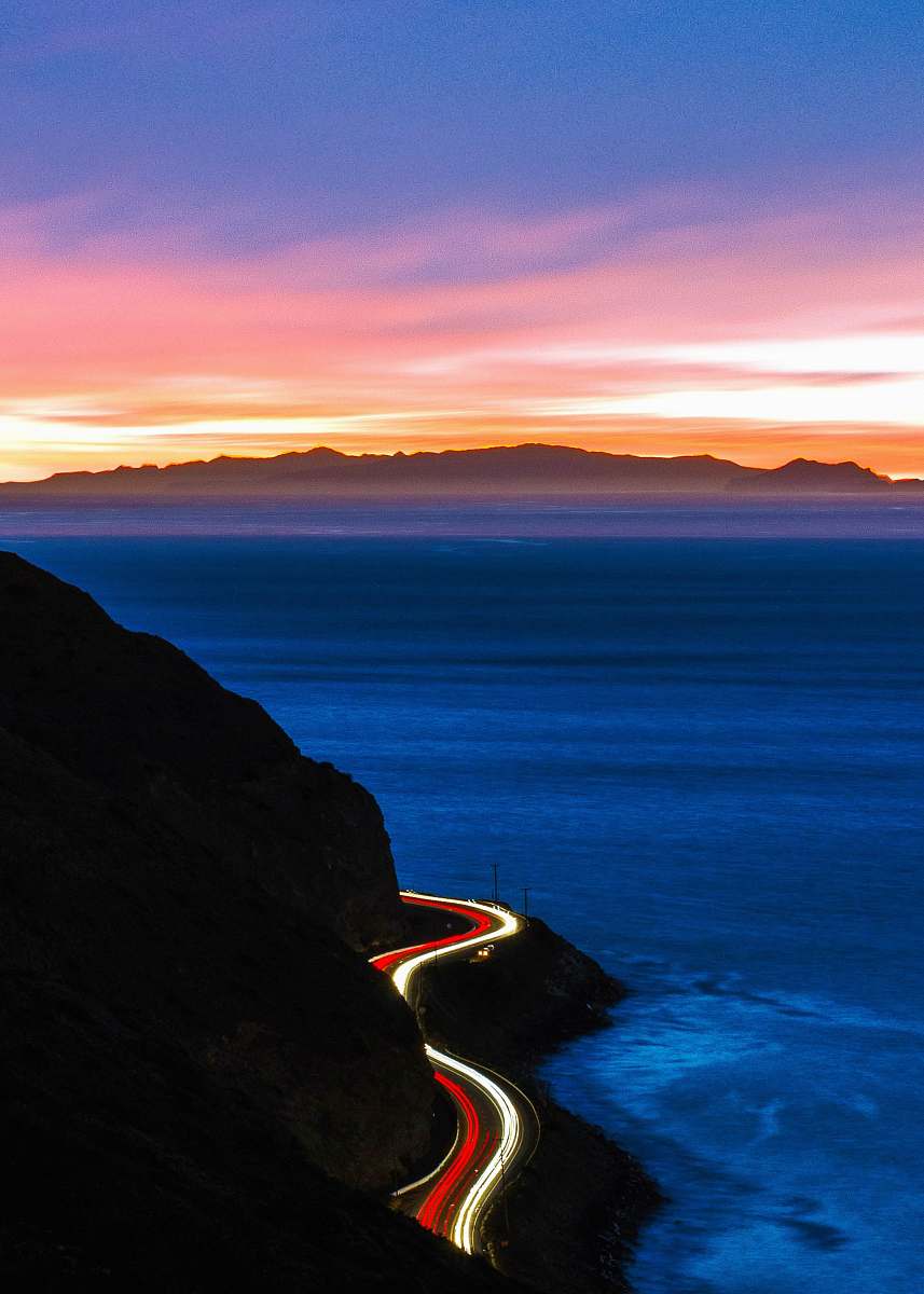 ocean time-lapse photography of cliff road during golden hour malibu