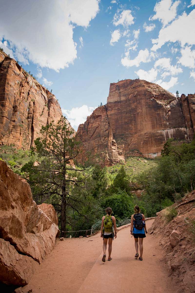 mountain two women walking in front of trees outdoors