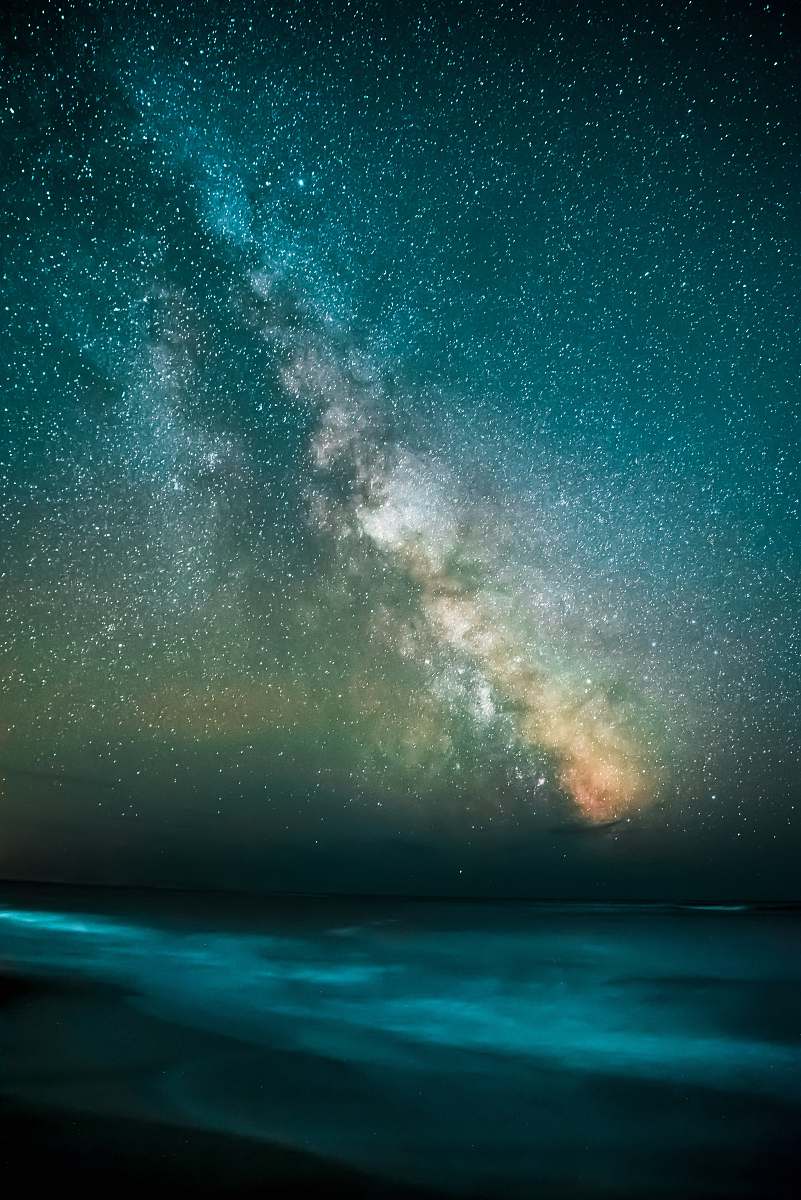 sky stars overlooking body of water during nighttime space