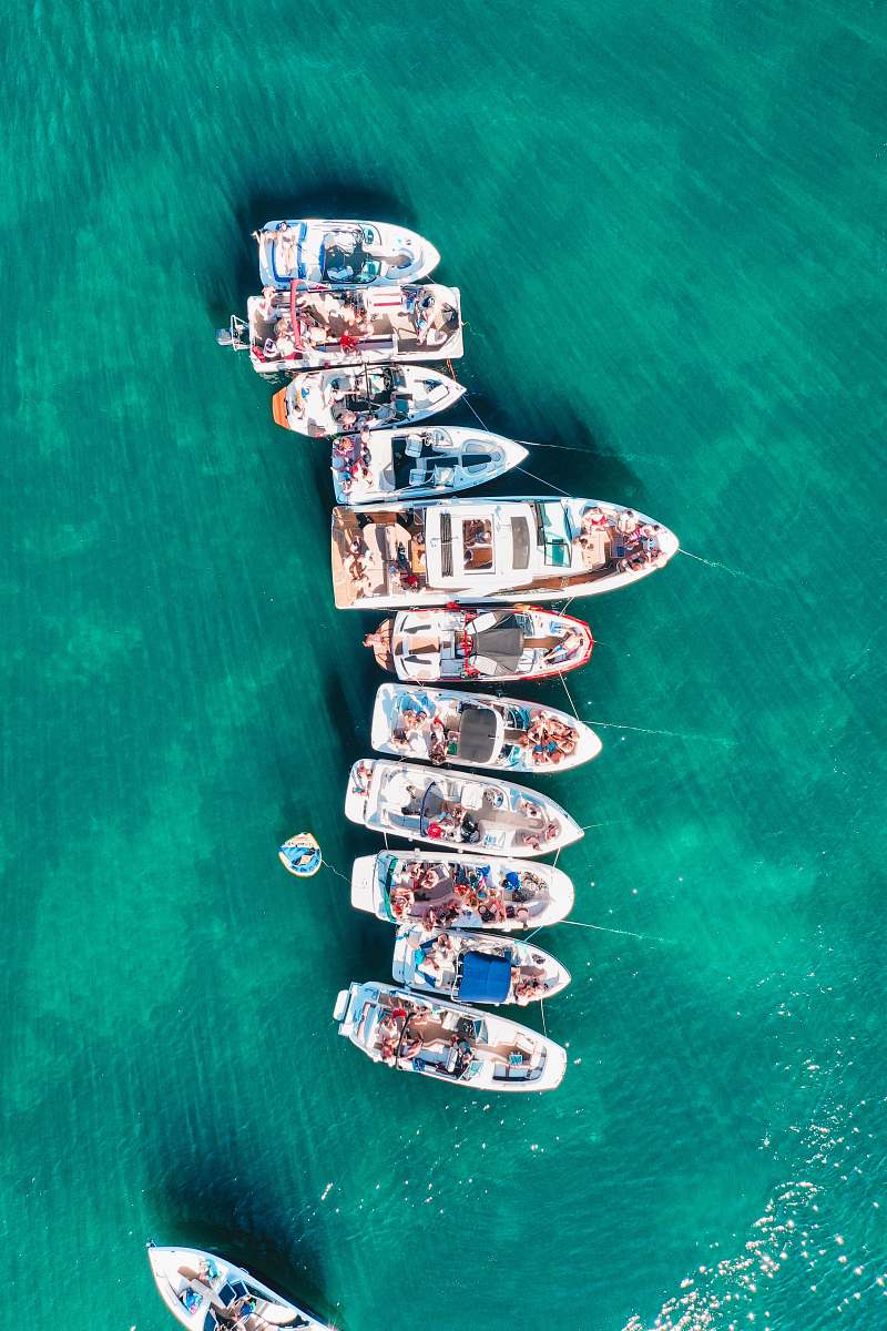 water aerial photo of boats on body of water during daytime waterfront
