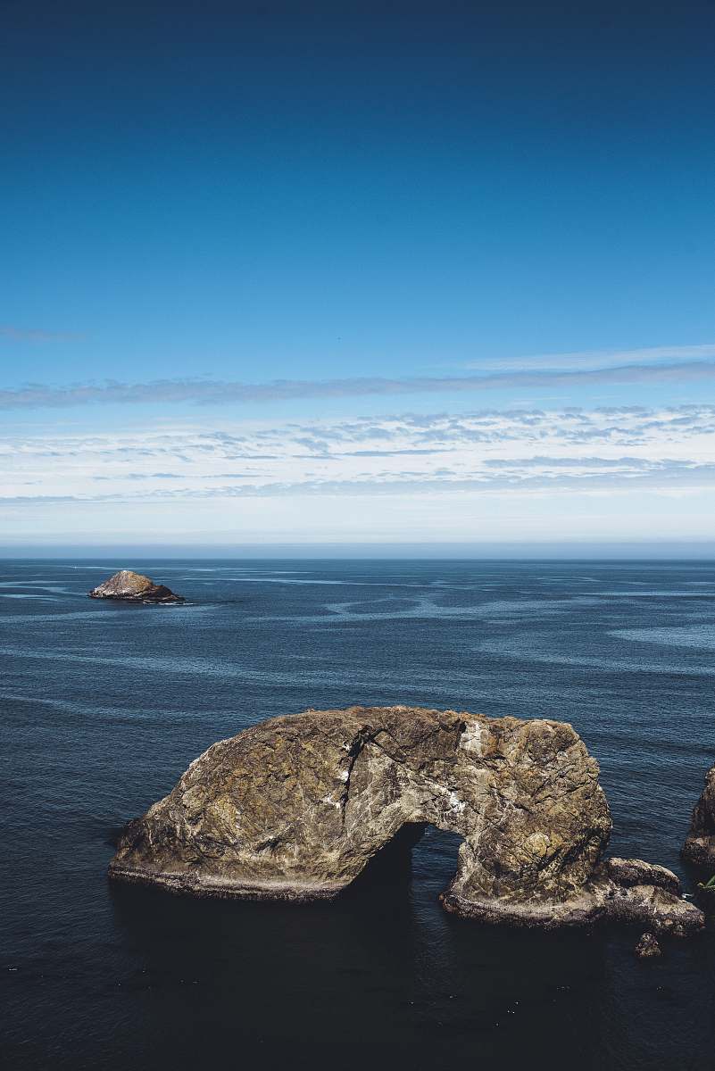 nature rock formation on body of water outdoors