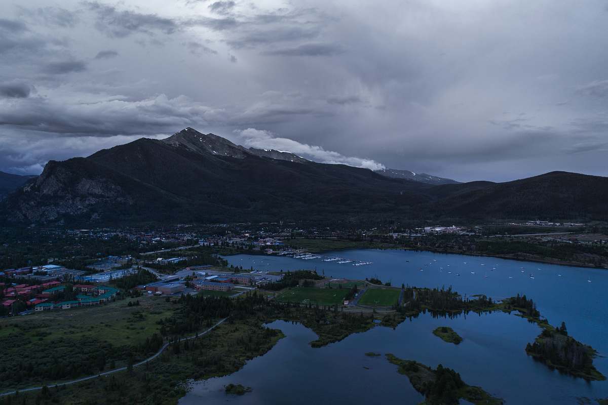 mountain aerial photo of body of water near mountains mountain range