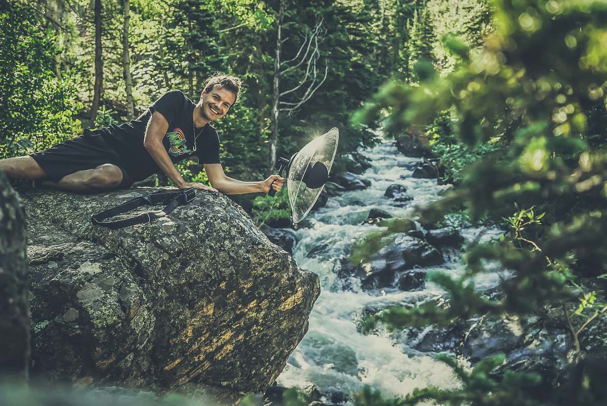 plant man lying on gray rock formation vegetation