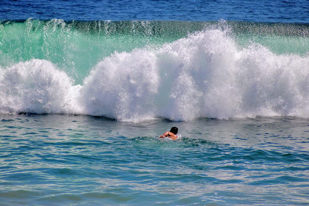 nature man surfing on sea waves during daytime ocean