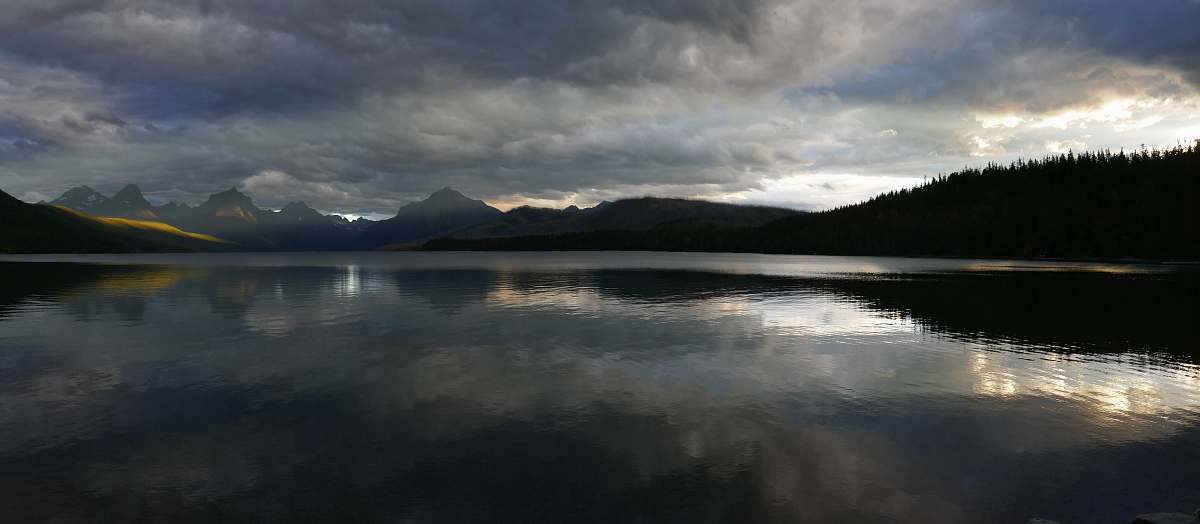 water mountains near body of water under cloudy sky nature