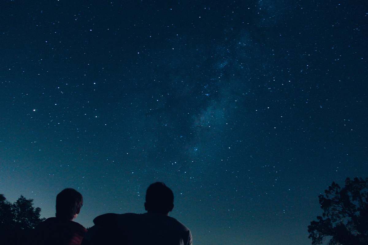 person silhouette photo of two person watching stars human