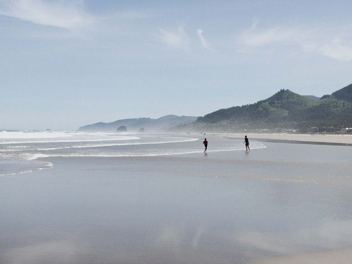 nature two person standing on seashore ocean