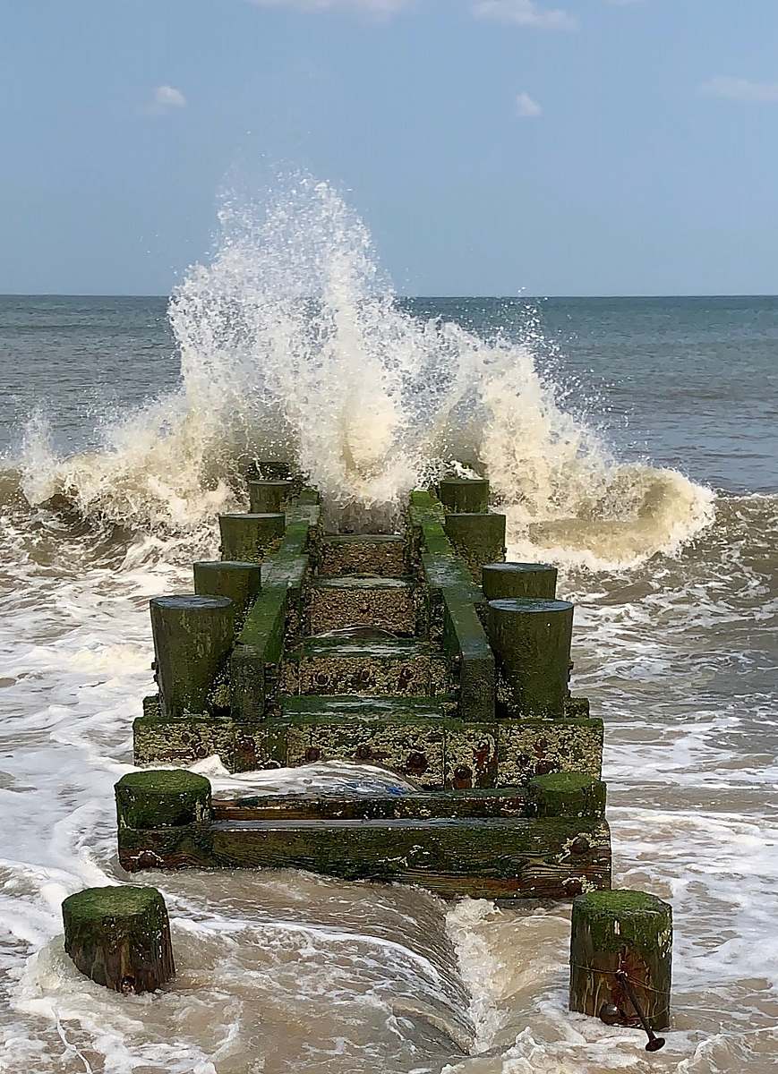 sea water wave beside sea dock ocean