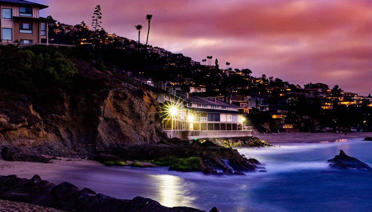 night white concrete house beside mountain in front body of water laguna beach