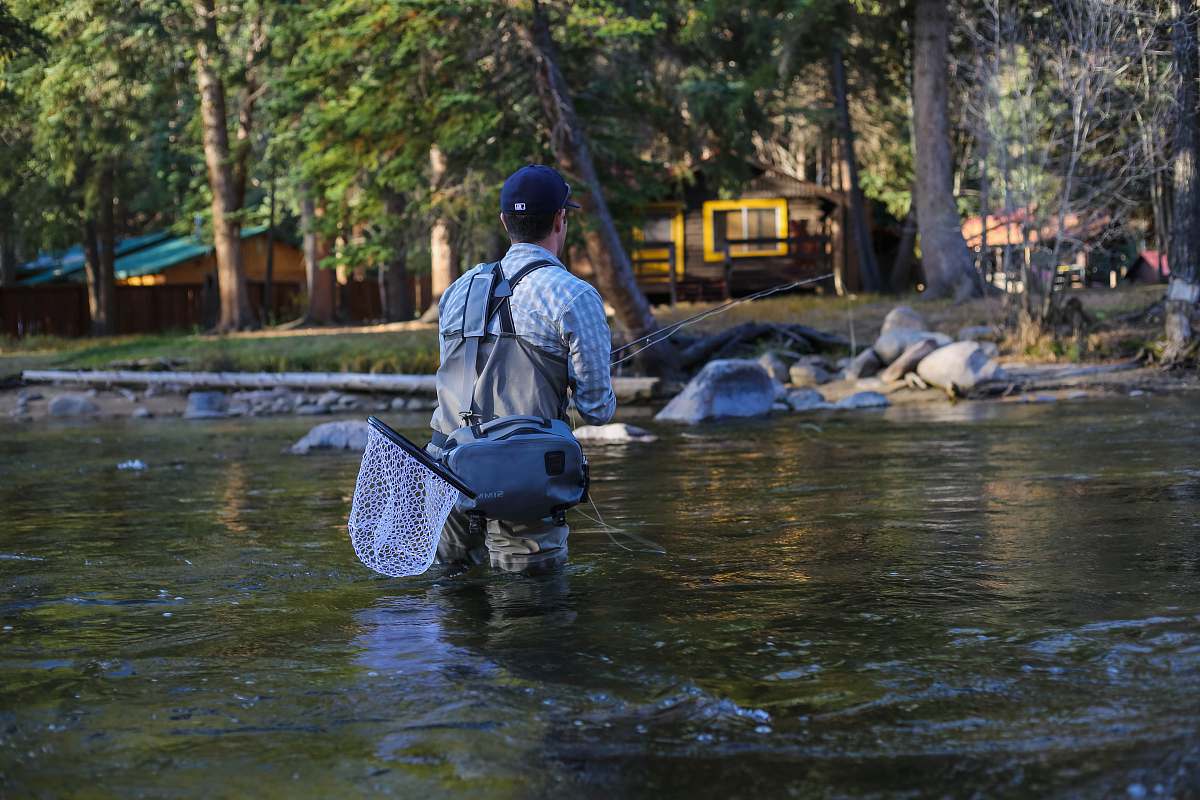 human man fishing river at daytime person