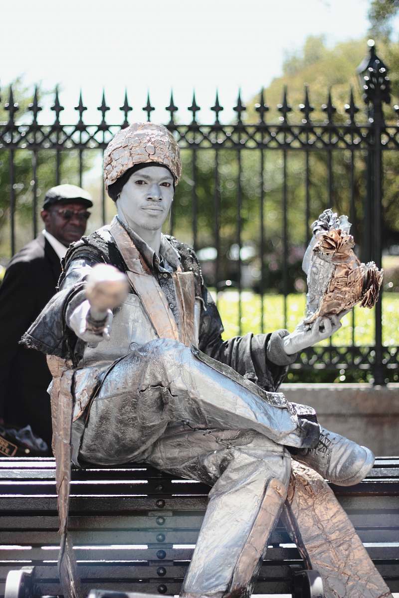 human man in white suit sitting on bench person