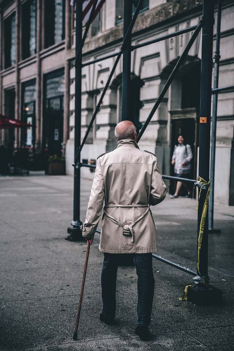 human man walking near scaffolding during daytime person