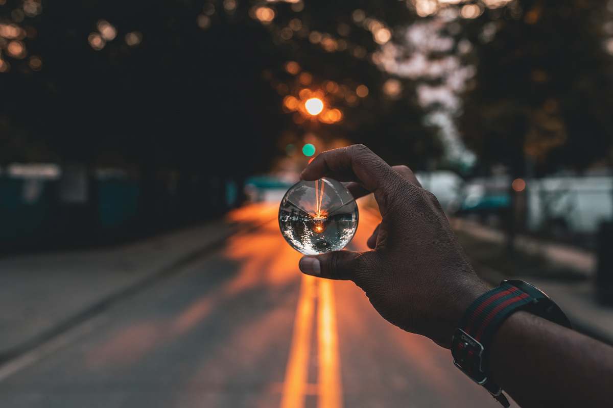 human person holding snow globe under sunset person