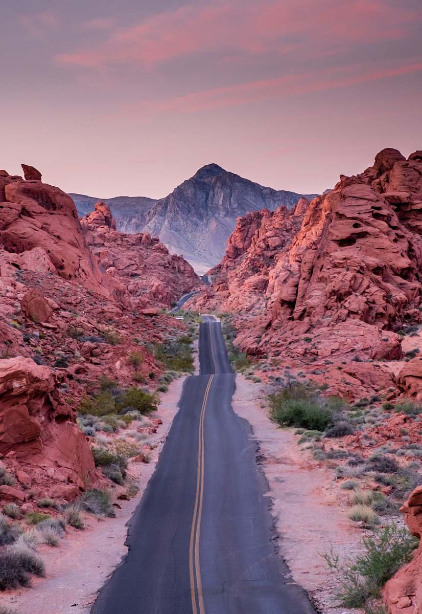 human photo of empty road between rock formations person