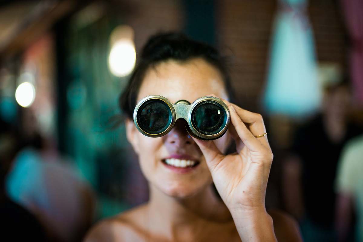 human woman using gray binoculars person
