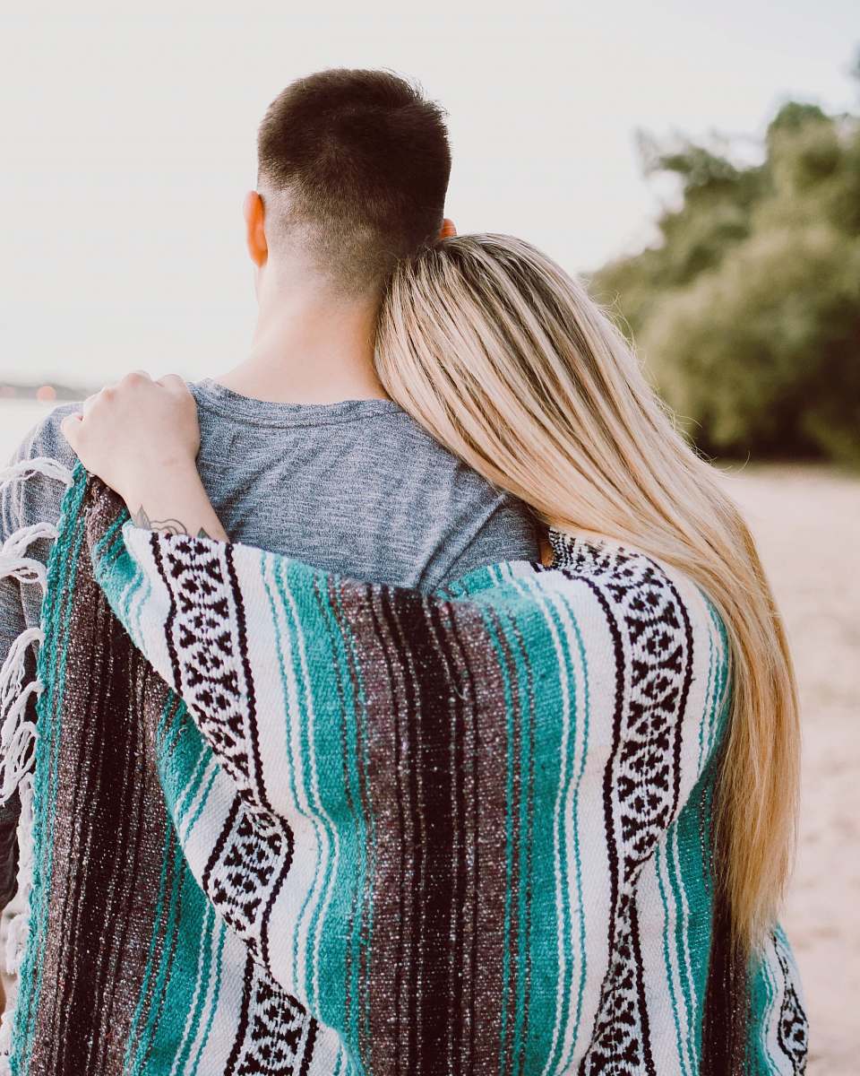 woman woman's hand on man's shoulder blonde