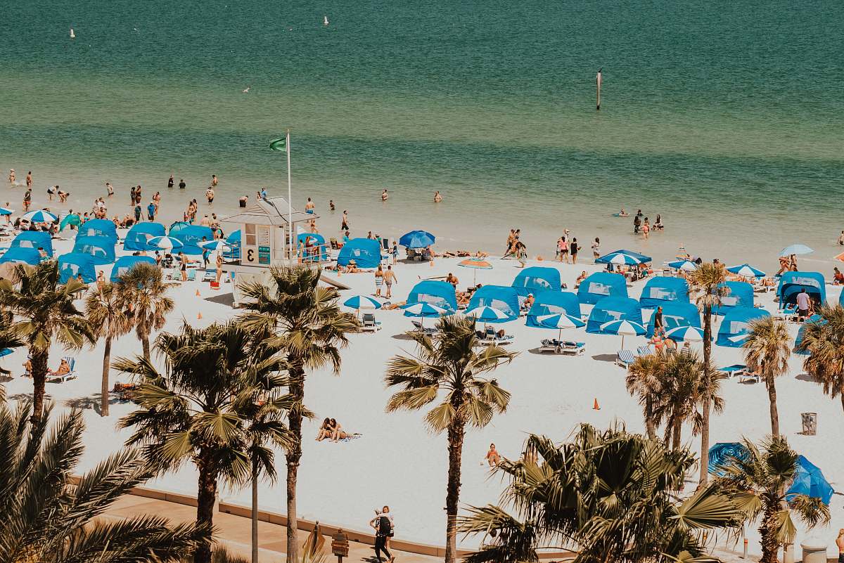 human blue and white tents in beach with people summer