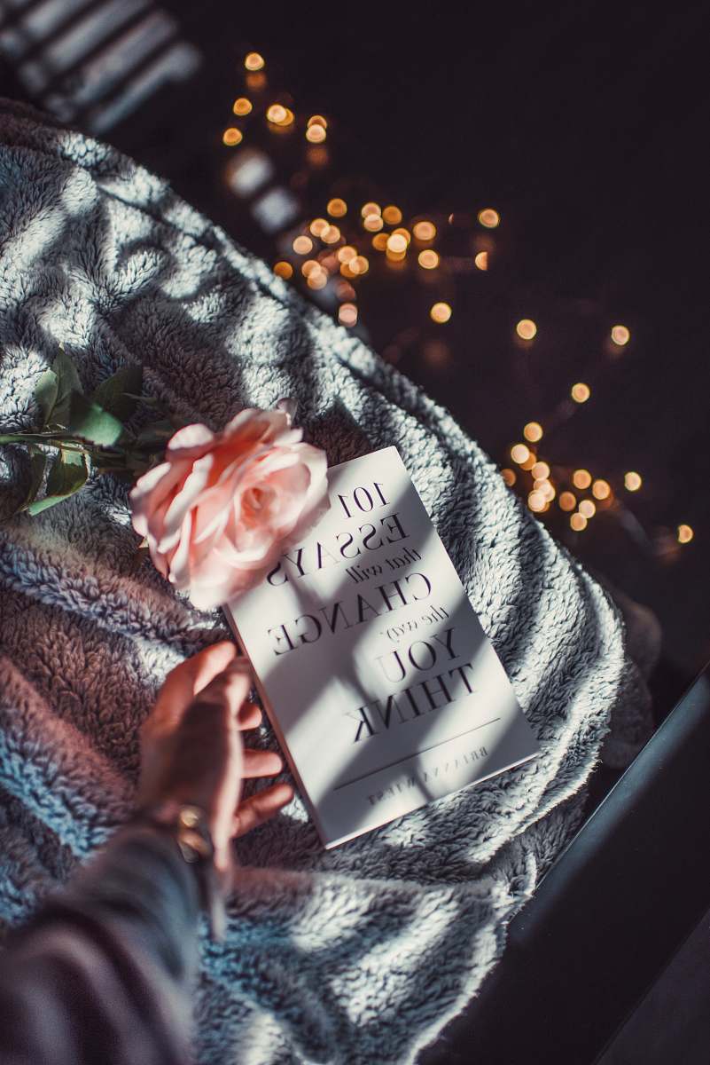 people book and peach flower on gray textile human