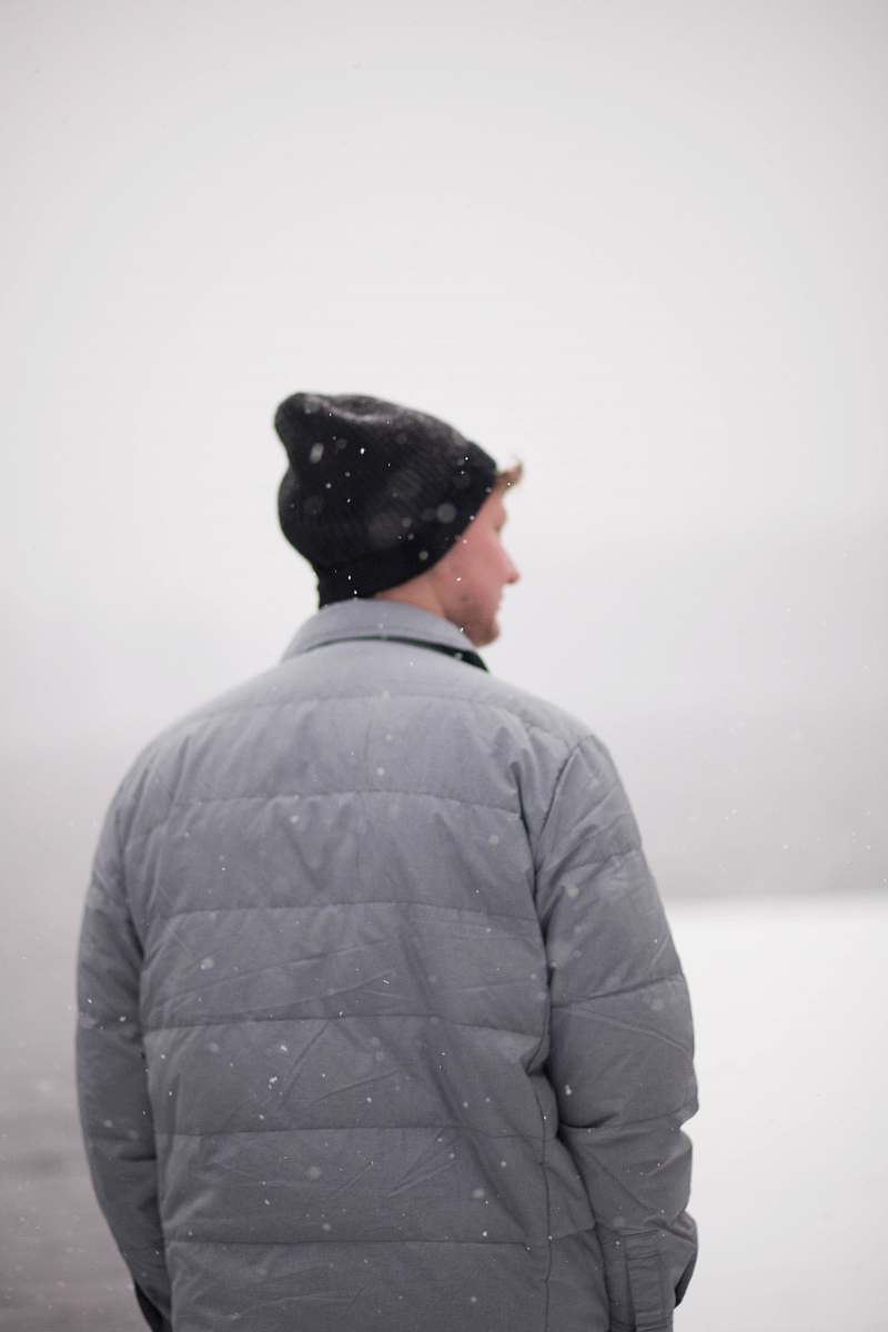 people man wearing gray jacket under snow human