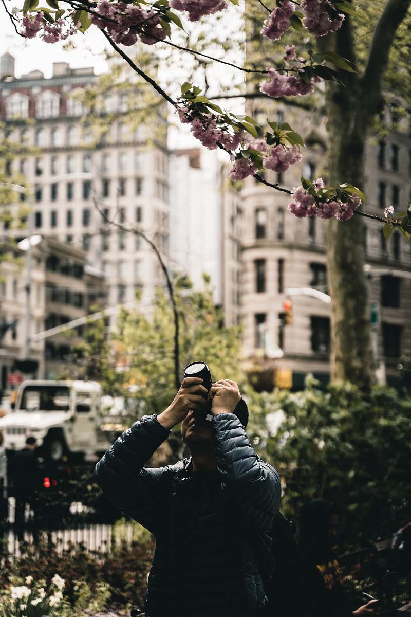 human men holding a camera during daytime new york