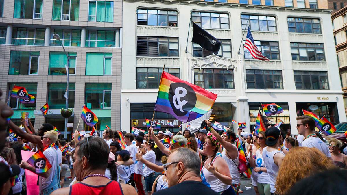 human people holding pride flag flag
