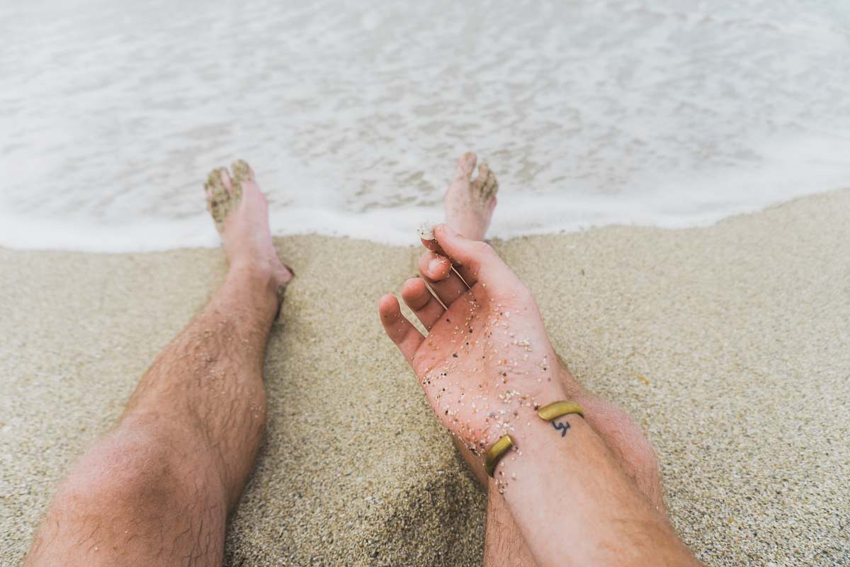 human person sitting near beachline people