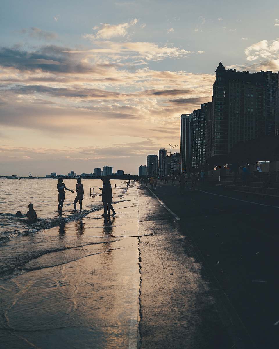human silhouette of people in shore lake michigan
