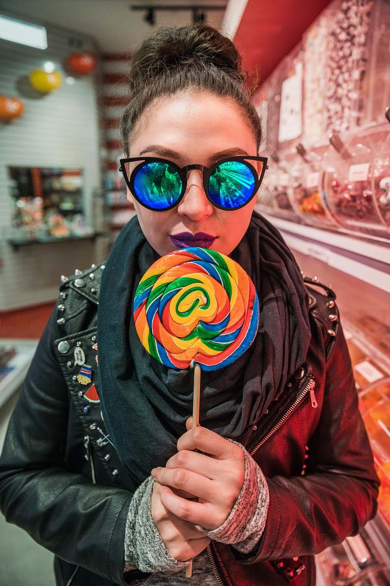human woman holding multicolored lollipop people