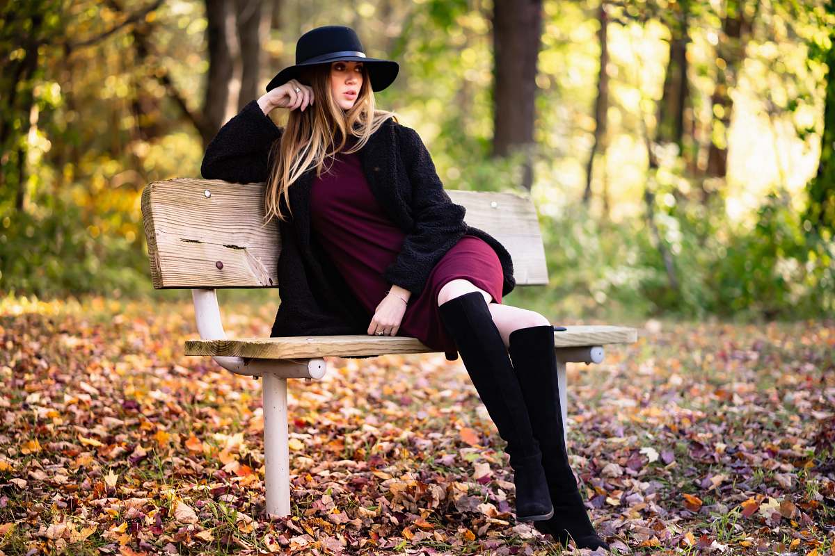 human woman sits on bench people