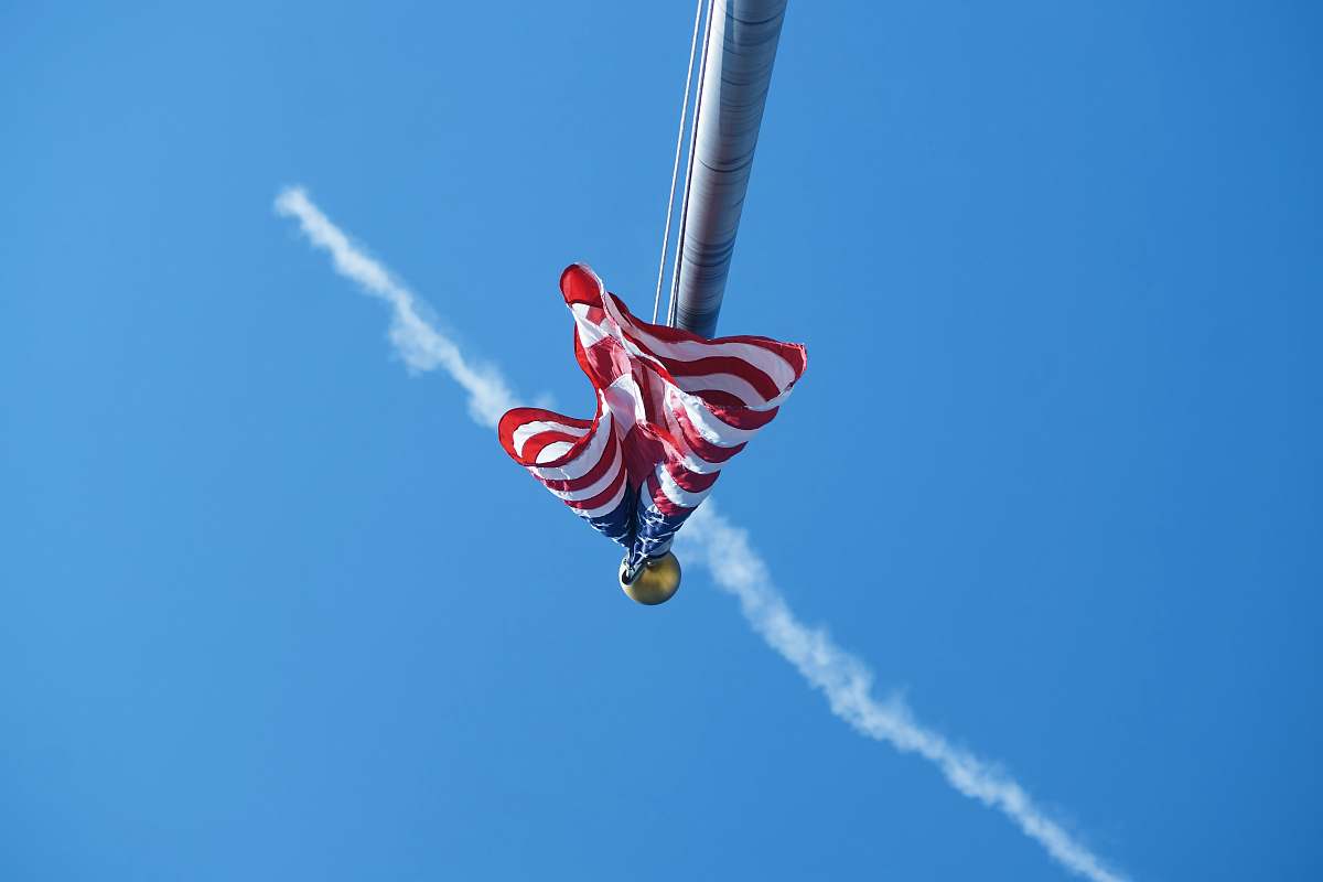 human worm's-eye view photography of USA flag in pole people