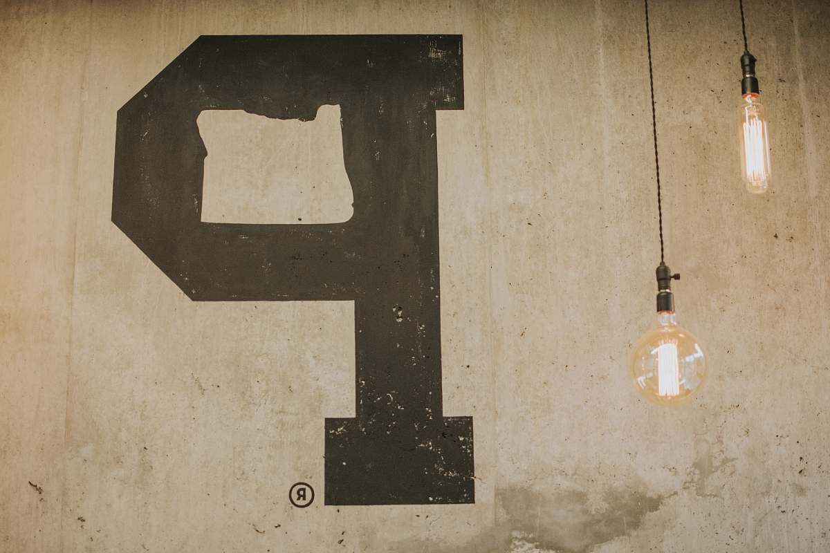 text two pendant lamp near beige wall with P letter alphabet