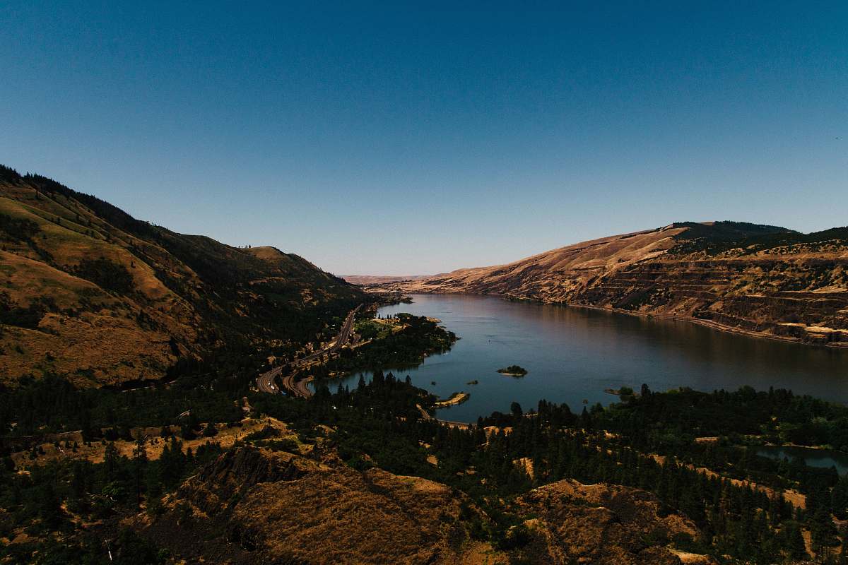 nature aerial photography of body of water near mountain outdoors